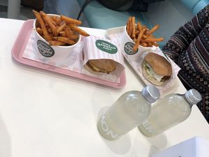 Cheese burger and chick’n burger with sweet potatoes fries. “Gingerade” made with Fairtrade ingredients. at Neat Burger - Oxford Circus in London