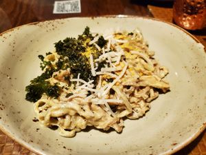 Homemade vegan pasta with crispy kale, creamy cashew cheese sauce, and vegan parmesan at Liquid Assets in Ocean City