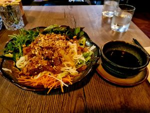 Rice noodles with veggies and tofu and several toppings at Soy in Munich