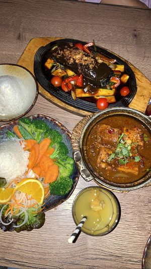 Top: Cha Ca (Marinated tofu with oyster mushrooms wrapped in seaweed sheets, tomatoes, zucchini, dill and spring onions, refined with lemongrass and galangal. Served with rice).  at Soy in Munich