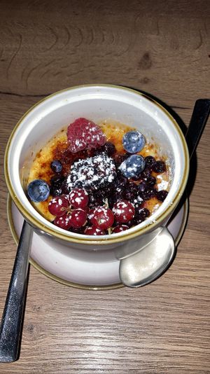 Banh Kem Dua - Creme Bruleé made from vanilla | coconut with a slightly sweet ginger-agave sauce | fruit mix  at Soy in Munich