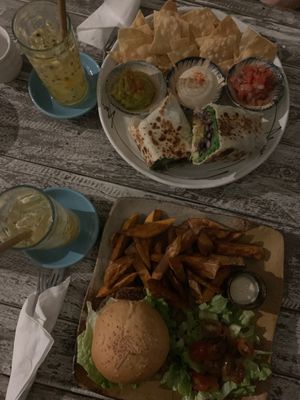 Our order - meaty mushroom burger with sweet potato fries and salad and the bean burrito with nachos at Sacred Lotus Cafe in Phnom Penh