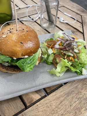 Cheeze burger with mushroom patty and side of salad  at Sacred Lotus Cafe in Phnom Penh