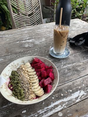 Dragon fruit bowl with an iced oat milk latte  at Sacred Lotus Cafe in Phnom Penh
