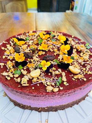 Torta Crudivegana de Frutos Rojos cubierta de flores comestibles, semillas y frutos secos   at Eco Tienda Café in Asuncion