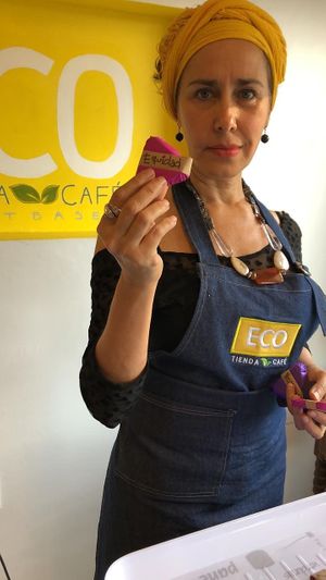Lu showing a piece of Mexican cacao 100% at Eco Tienda Café in Asuncion