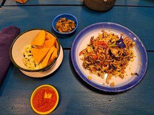 Fried chickpea tofu with tomato turmeric sauce, pickles, Burmese green tea leaf salad  #Veganuary at Free Bird Cafe in Chiang Mai