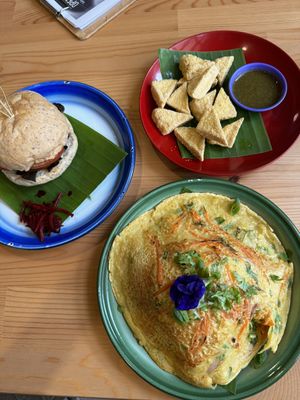 Jackfruit meat burger, deep fried tofu with garlic coriander sauce and chickpea omelet with rice  at Free Bird Cafe in Chiang Mai