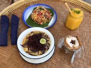 Clockwise - Shan noodles, mango smoothie, Dirty chai latte, Khao Soi  at Free Bird Cafe in Chiang Mai