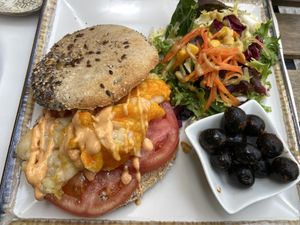 Tostada, scrambled vegan eggs, tomato and Siracha mayo   at Veganitessen in Sevilla