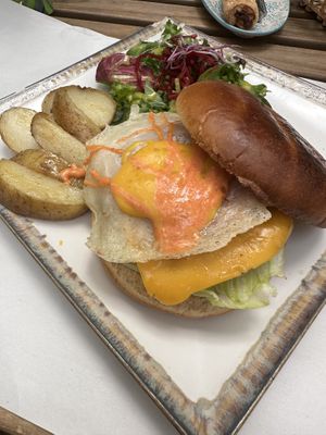 Fried egg and bacon cheeseburger on brioche bun  at Veganitessen in Sevilla