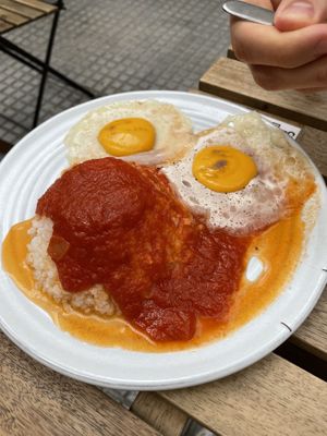 Vegan fried eggs with rice and tomato sauce  at Veganitessen in Sevilla