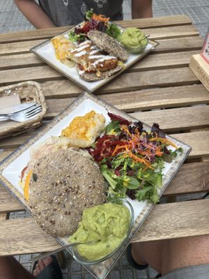 English breakfast (near) & Spanish omelette (far) both with an extra side of scrambled eggs & guac   at Veganitessen in Sevilla