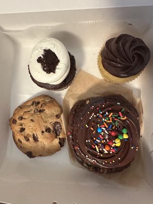 Devils food cupcake, vanilla with chocolate frosting, cosmic brownie bun, and walnut chocolate chip cookie  at For Goodness Cakes - Food Truck in Baiting Hollow
