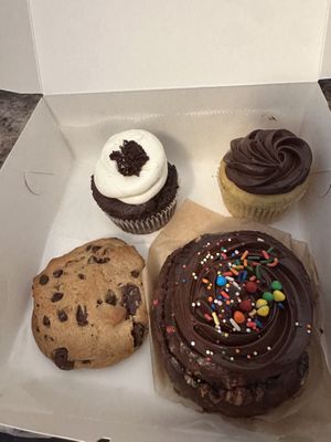 Devils food cupcake, vanilla with chocolate frosting, cosmic brownie bun, and walnut chocolate chip cookie  at For Goodness Cakes - Food Truck in Baiting Hollow