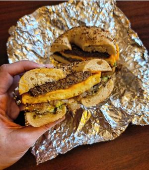 Vegan Just Egg and cheese on an everything bagel with Beyond sausage, hashbrown, and avocado at Roland Park Bagels in Baltimore