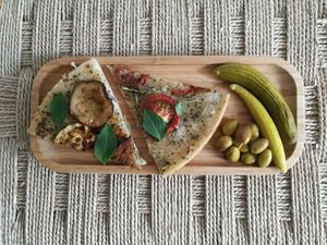 Focaccia made from rice flour tooped with mediterranean herbs, eggplants, tomato and olive oil  at Fina in Beirut