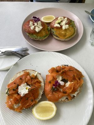 Brooklyn boy everything bagels  - top is the avocado, tomato + feta ,other is the cream cheese (carrot) salmon, dill and capers   at Oh My Days in Glebe
