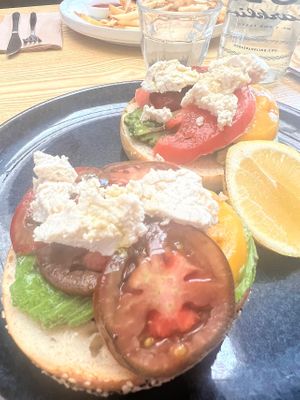 Bagel with avocado, tomatoes and feta  at Oh My Days in Glebe