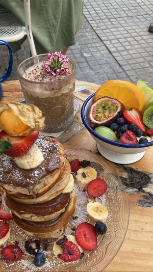 Brunch spread (chai latte, chocolate pancakes, fruit bowl)  at Mama Carmen's Coffee & Bakery in Mallorca
