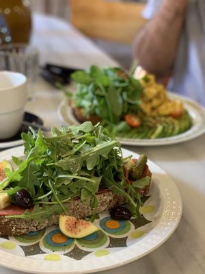 Spinach bun, tomato, avocado ”scrambled eggs” and salad toast.
 at Mama Carmen's Coffee & Bakery in Mallorca