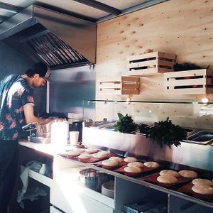 Freshly formed buns waiting in a line to be put into oven at Enjoy Moon in Oslo