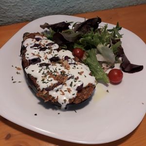Berenjena asada  rellena con salsa de champiñones, aceitunas y salsa alioli con leche de soja ( vegan) at Kalí Órexi by Labocatorio in Bilbao