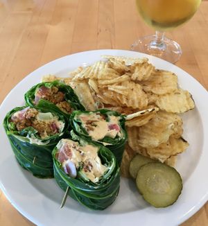 Vegan Mediterranean Wrap. Tasty with well-balanced ingredients. The collard green "shell" contributes a slight “leafy” taste but does not overpower. at Olivia's Organic Cafe in Burnsville