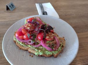 Smashed avo toast - sourdough, avo, pickled onion tomato, dukkah and microherbs ($14 Oct 2023) at Grit Cafe in Goulburn