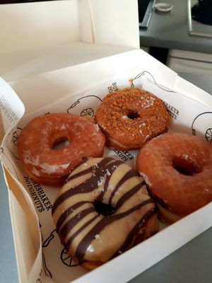 Regular, banana cream pie special, peanut/ chocolate at Boneshaker Doughnuts in Paris