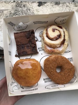Different selection of foods at Boneshaker Doughnuts in Paris