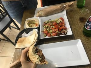Two sandwiches, hummus, and salad at Sham Falafel in Krakow