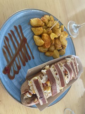 Vegan hot dog with “bacon”, great tofu dressing, needs more flavor   at Alma y Café in Cali