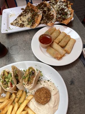 The pizza is not vegan. Falafel wrap and spring rolls are vegan   at Middl.eat  in Amsterdam