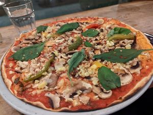 Vegan pizza with little vegan cheese crumbs at Il Forno in Stockholm