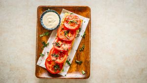 Kamuela tomato, local basil, olive oil, salt on a breadfruit sourdough toast. Comes with a side of our secret sauce!  at Journey Cafe in Kailua Kona
