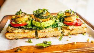 Roasted eggplant, kale, zucchini, sweet & spicy cherry peppers, cashew parmesan, basil, olive oil on a homemade breadfruit sourdough.
 at Journey Cafe in Kailua Kona