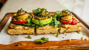 Roasted eggplant, kale, zucchini, sweet & spicy cherry peppers, cashew parmesan, basil, olive oil on a homemade breadfruit sourdough.
 at Journey Cafe in Kailua Kona
