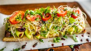 Avocado, artichoke hearts, kalamata olives, clover sprouts, tomatoes, cherry peppers, roasted garlic, cilantro, olive oil at Journey Cafe in Kailua Kona