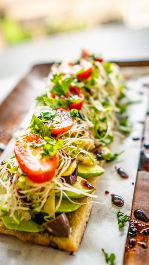 Avocado, artichoke hearts, kalamata olives, clover sprouts, tomatoes, cherry peppers, roasted garlic, cilantro, olive oil at Journey Cafe in Kailua Kona