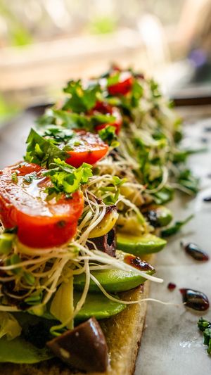 Avocado, artichoke hearts, kalamata olives, clover sprouts, tomatoes, cherry peppers, roasted garlic, cilantro, olive oil at Journey Cafe in Kailua Kona