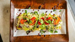 Avocado, artichoke hearts, kalamata olives, clover sprouts, tomatoes, cherry peppers, roasted garlic, cilantro, olive oil at Journey Cafe in Kailua Kona