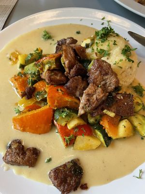 Oven-baked pumpkin with soy chunks, polenta and celery sauce  at Landia in Vienna