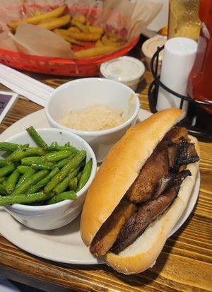 Vegan bratwurst with mushrooms. Sourkraut and green beans on the side. Pickled fries appetizer. at The Troll Tavern in Helen