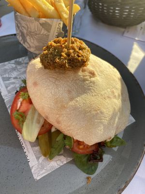 Pita falafel with tomatoes, pickles, mint and parsley. Specify vegan when ordering bc it normally comes with a yoghurt dressing that isn’t written down on the menu at Van der Valk in Goes