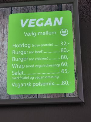 Vegan menu on screen above counter at Iscafeen in Hvide Sande