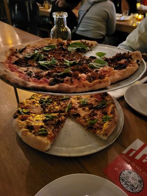 Pizza with vegan cheese and sausage at Delarosa - Chestnut St in San Francisco