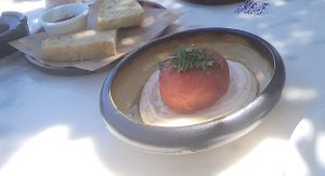 Homemade foccacia with extra virgin olive oil from their farm and Tomato 'Gemista' filled with quinoa, mint, raisins & side raita sauce at Med Cafe in Crete