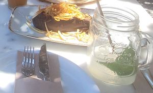 Smoked egg plant salad with string potatoes & mint lemonade with fresh mint, fresh lemon juice, soda and homemade mint syrup at Med Cafe in Crete