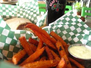 Organic beer on tap, sweet potatoe fries with chipotle mayo and a sandwich at Panthere Verte - Mile End in Montreal